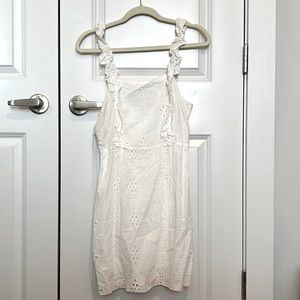 Cute off white springy dress! It has stretchy straps and a zipper in the back.